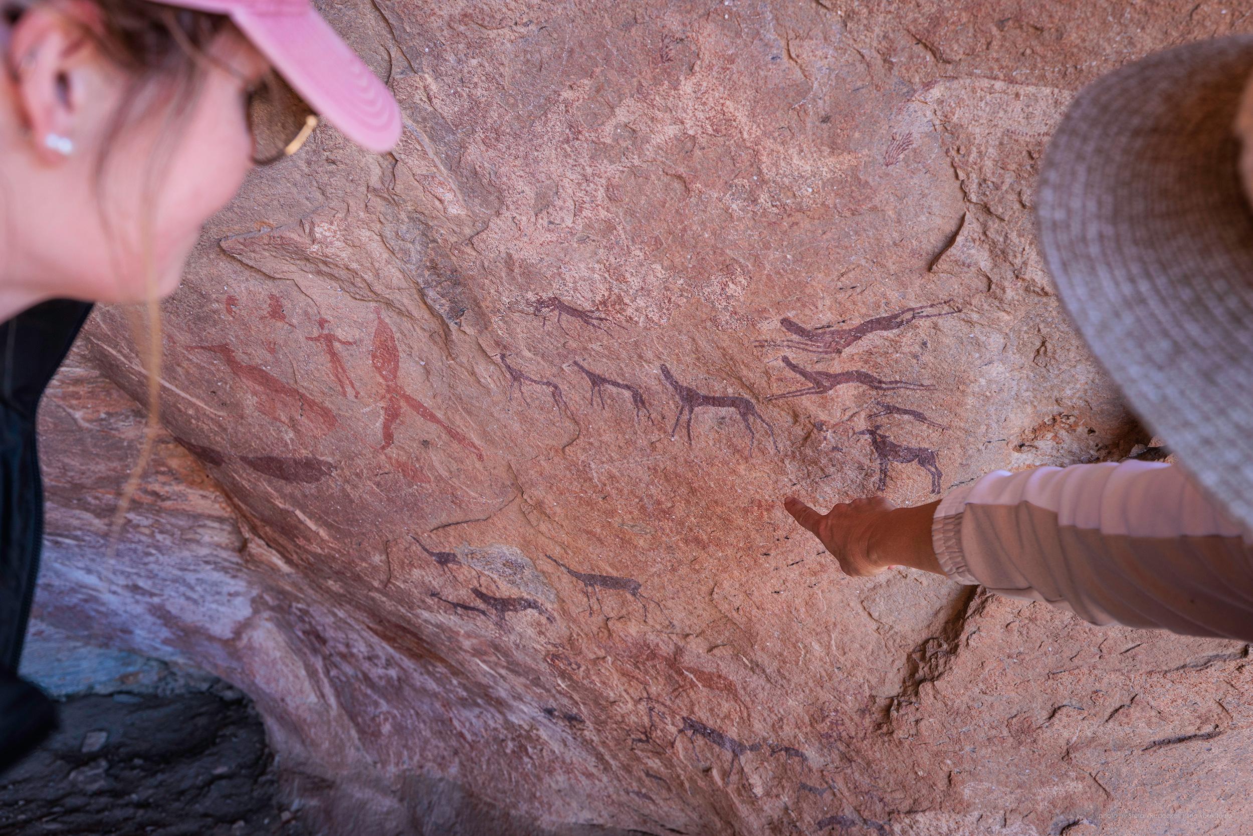 Ancient San Bushman rock art paintings on desert rock face in Namibia estimated over 1000 years old